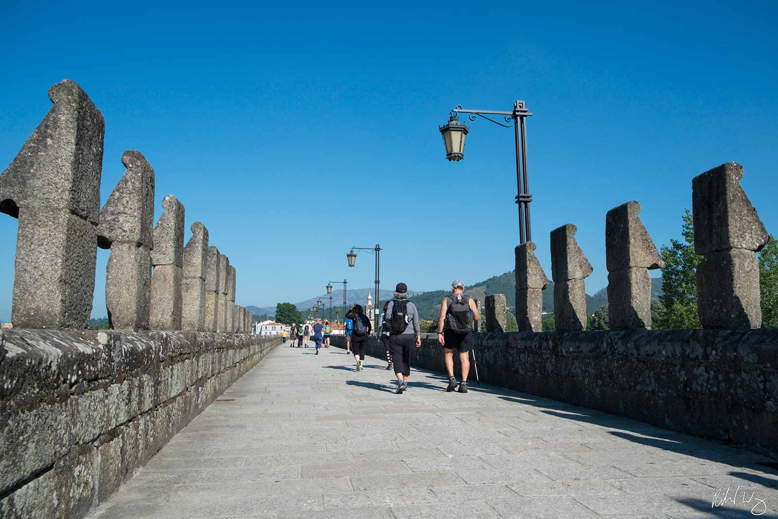 Walkers Crossing Medieval Bridge on Caminho Portugues Route, Ponte de Lima, Portugal