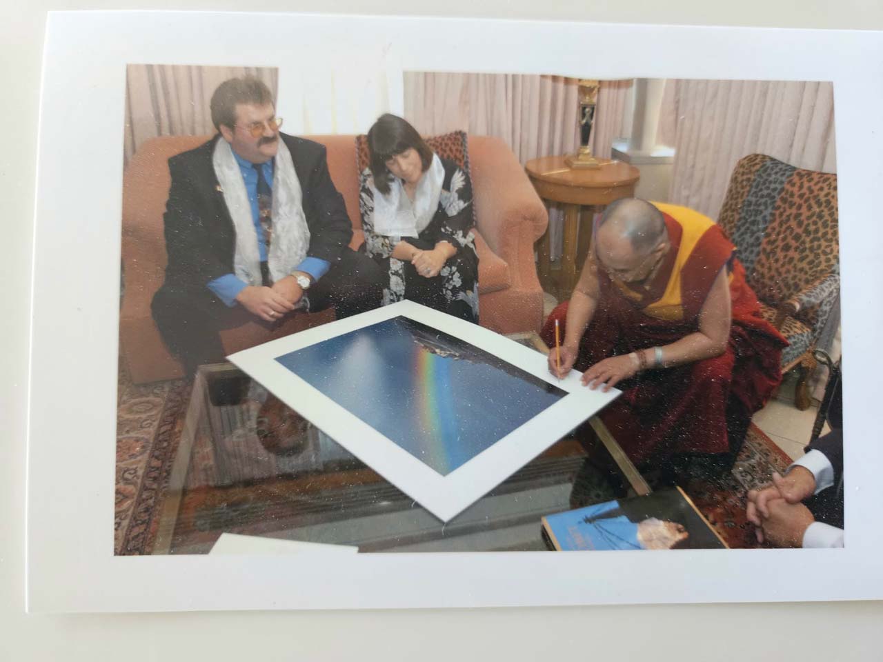 His Holiness The Dalai Lama Signing Galen Rowell's Rainbow Over Potala Palace Print